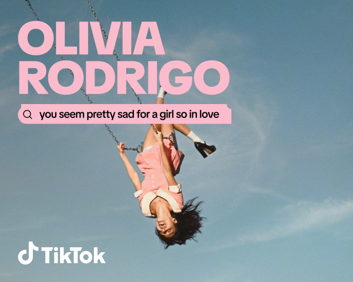 Artist card for Olivia Rodrigo showing her upside down on a swing against a blue sky, with the lyric 'you seem pretty sad for a girl so in love'